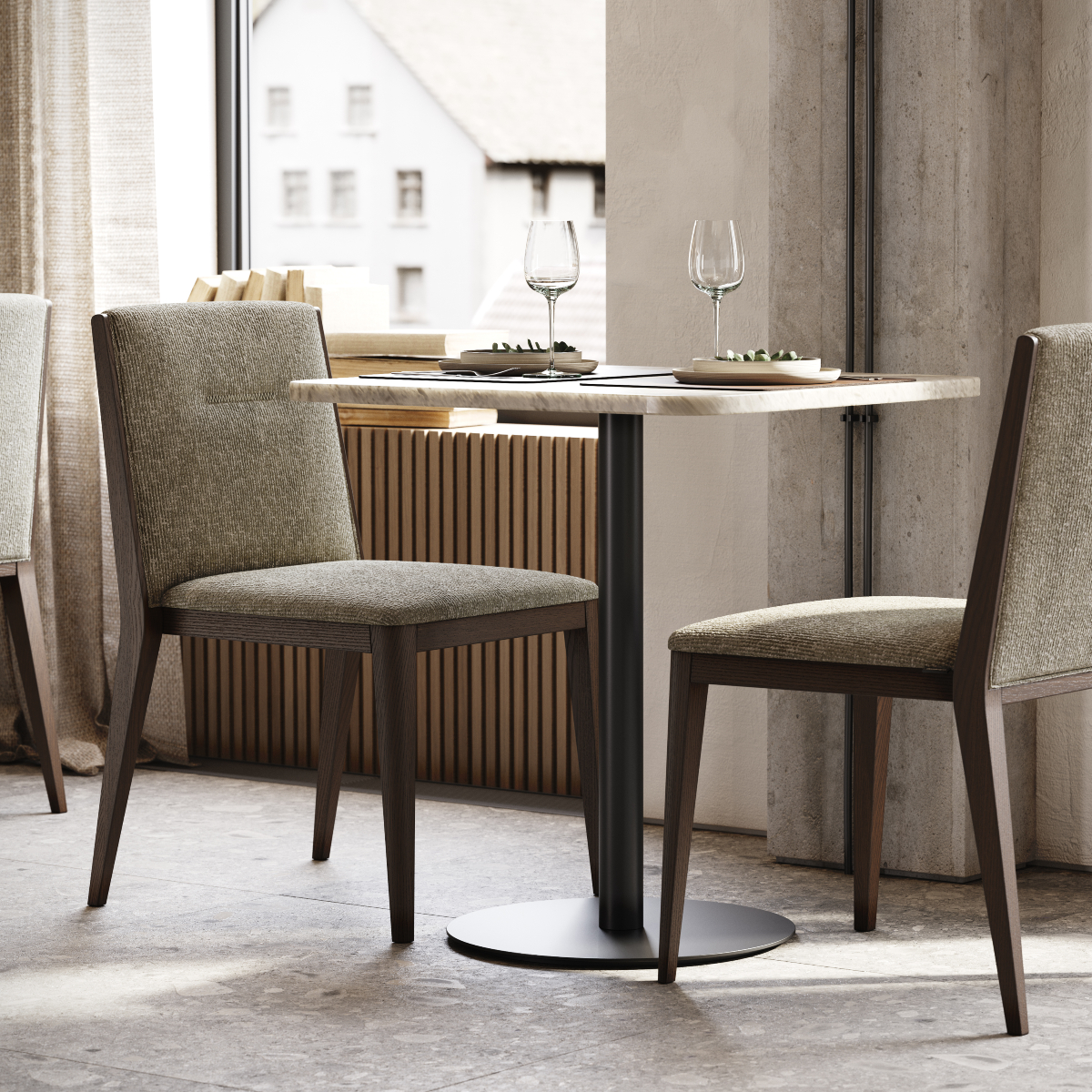 A cosy setup featuring a table and two chairs placed by a window, creating a bright and inviting atmosphere. 2025 dining room trends.