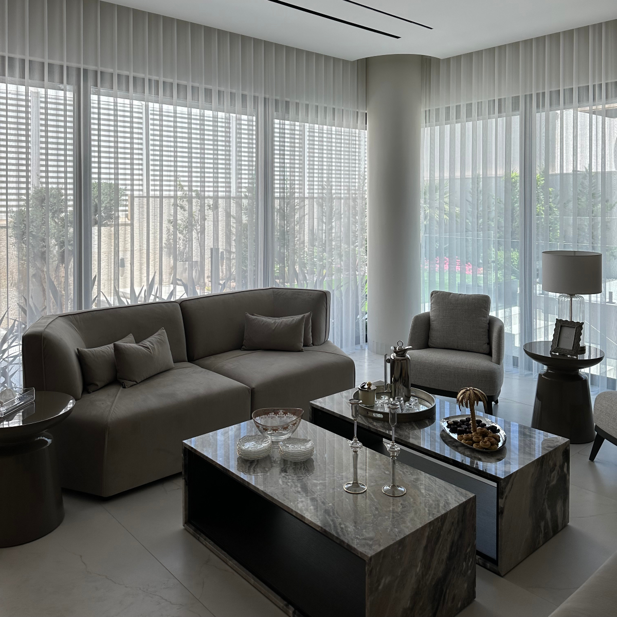 A modern living room by Etch & Notch Designs showcasing a sofa, a coffee table, and chairs, designed for comfort and social interaction.