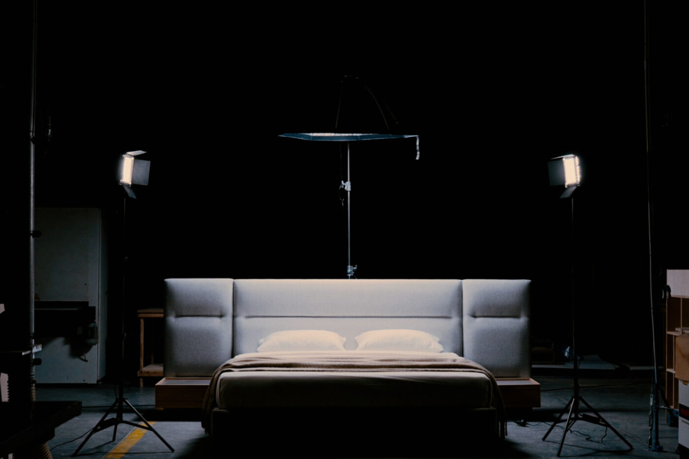 A bed adorned with a gentle light and a camera positioned on top, suggesting a creative space. Black Friday 2025