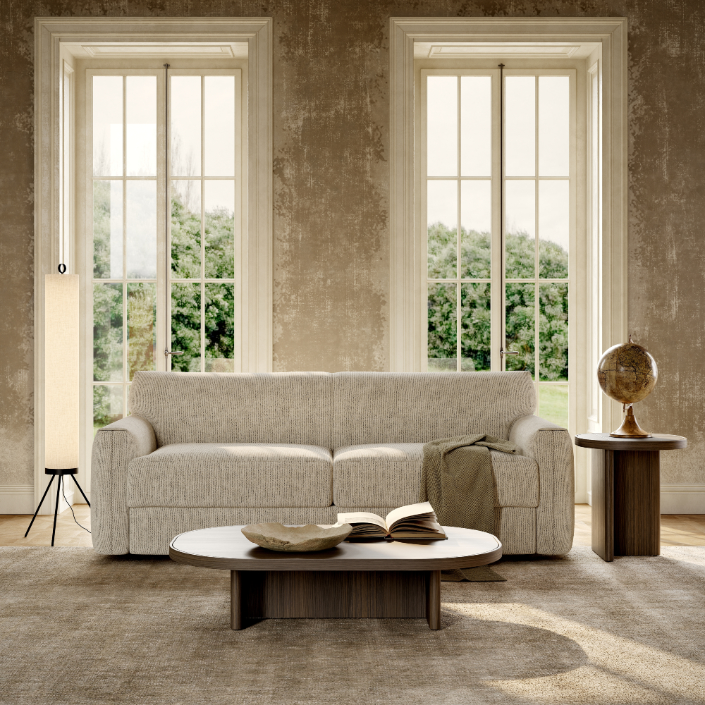 A bright living room with a comfortable sofa bed, a coffee table, and two windows enhancing the space's openness.