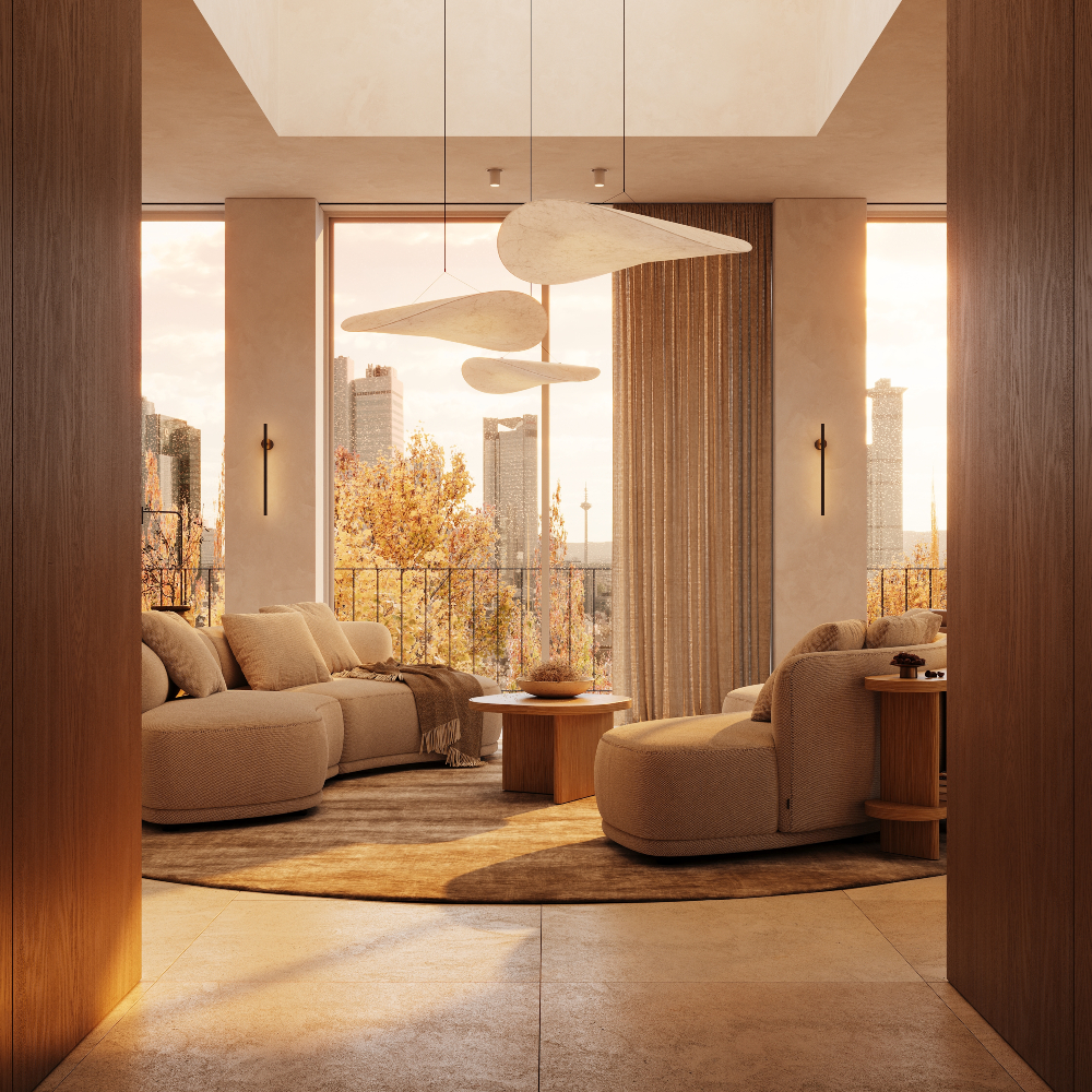 A corridor heading to a cosy lounge with a large circular modular sofa, a console and several armchairs arranged for conversation.