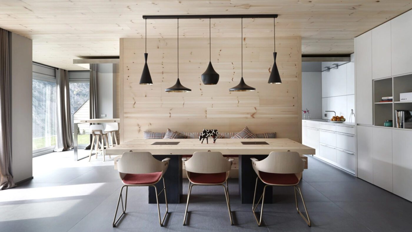 imgi_7_Sara_Riera_Coblonal_Arquitectura_Andorra_9897-scaled Stylish kitchen showcasing wooden walls and a modern table, blending elegance with a welcoming ambience.