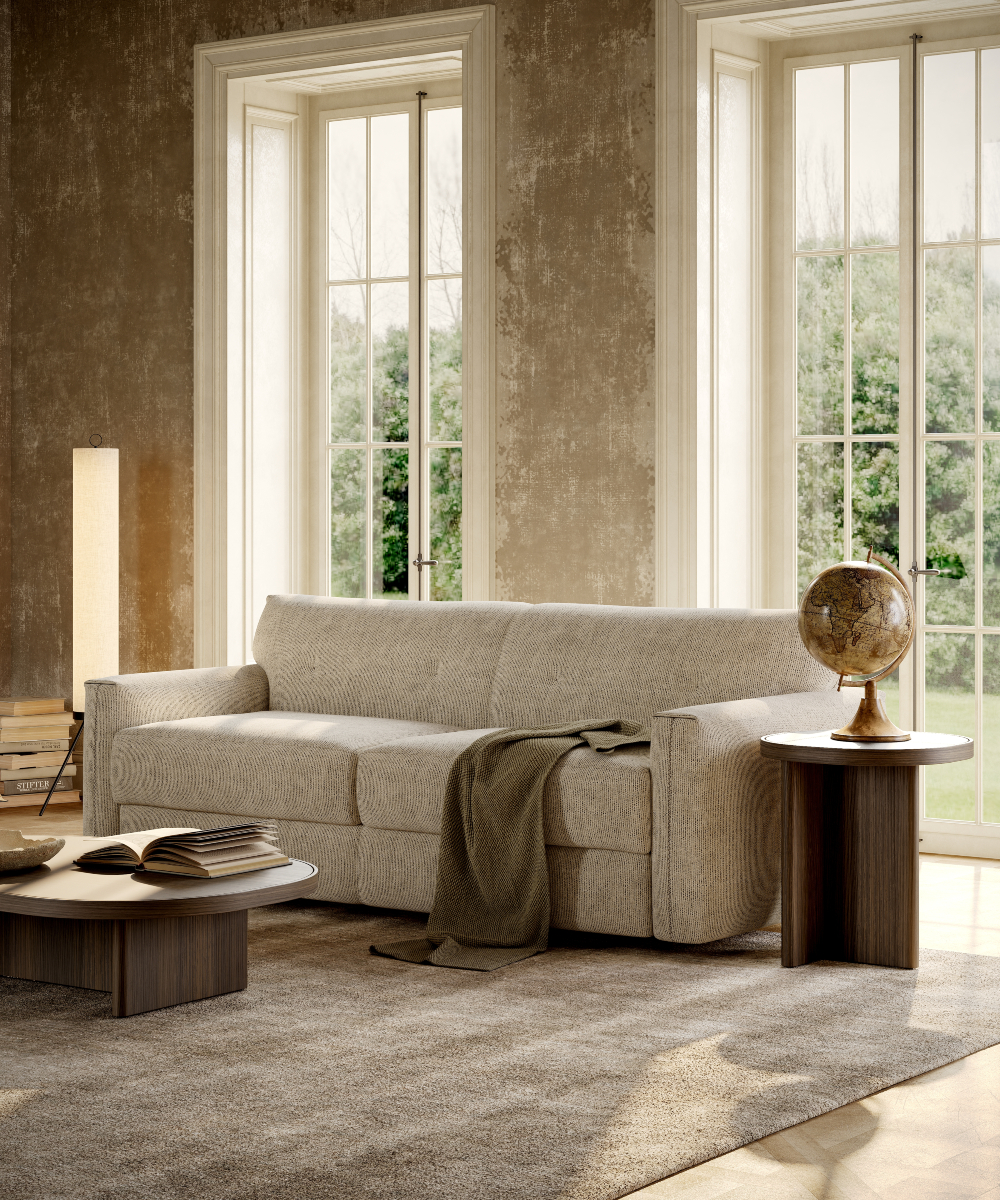 A welcoming living room scene with a sofa bed, a coffee table, and a window that brightens the space.