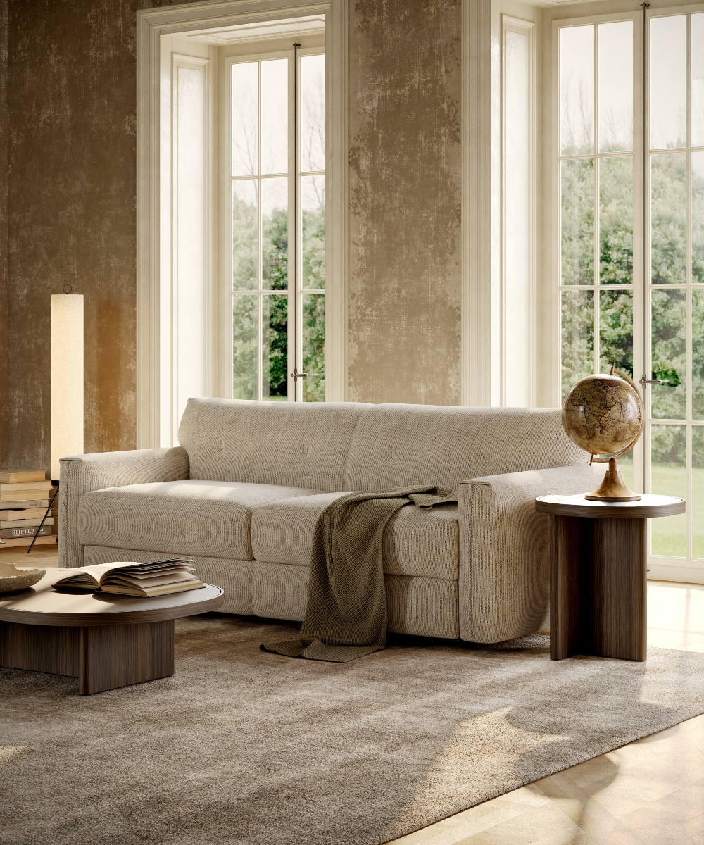 A welcoming living room with a comfortable sofa bed, a coffee table, and a large window for sunlight.
