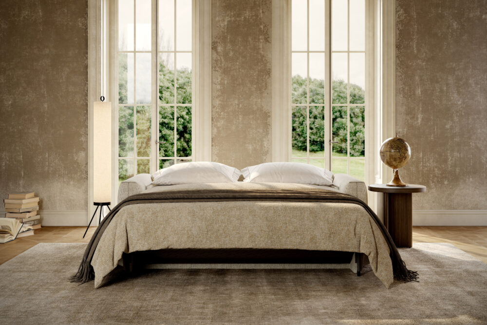 A cosy living room featuring a sofa bed, a bedside lamp, and a window letting in natural light.