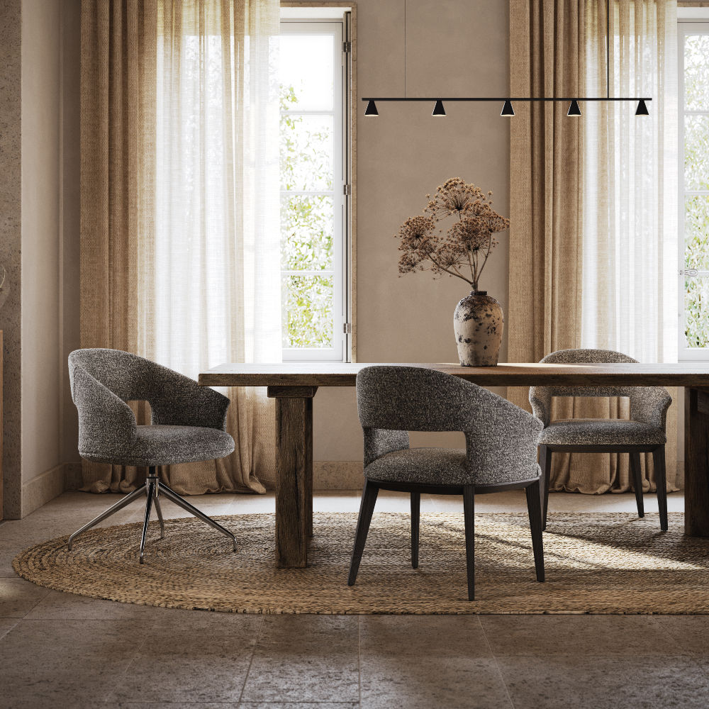 A bright home office with a round table and four chairs, decorated with a centrepiece and natural light streaming in.