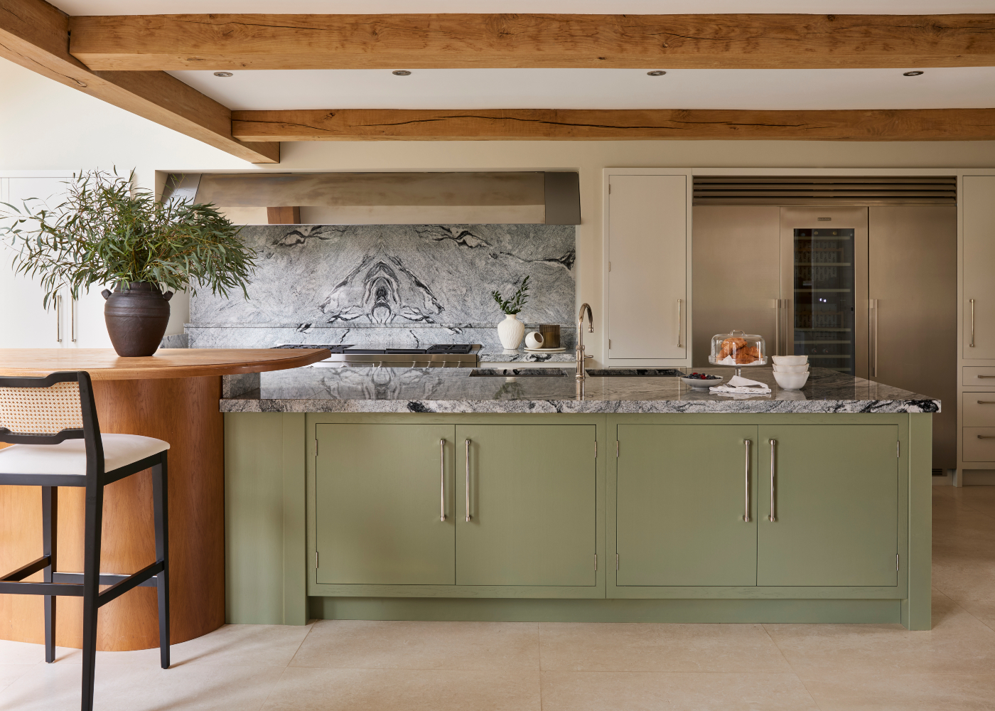 Bright kitchen in a modern heritage home with a vibrant green island and a cosy bar, perfect for cooking and socialising.