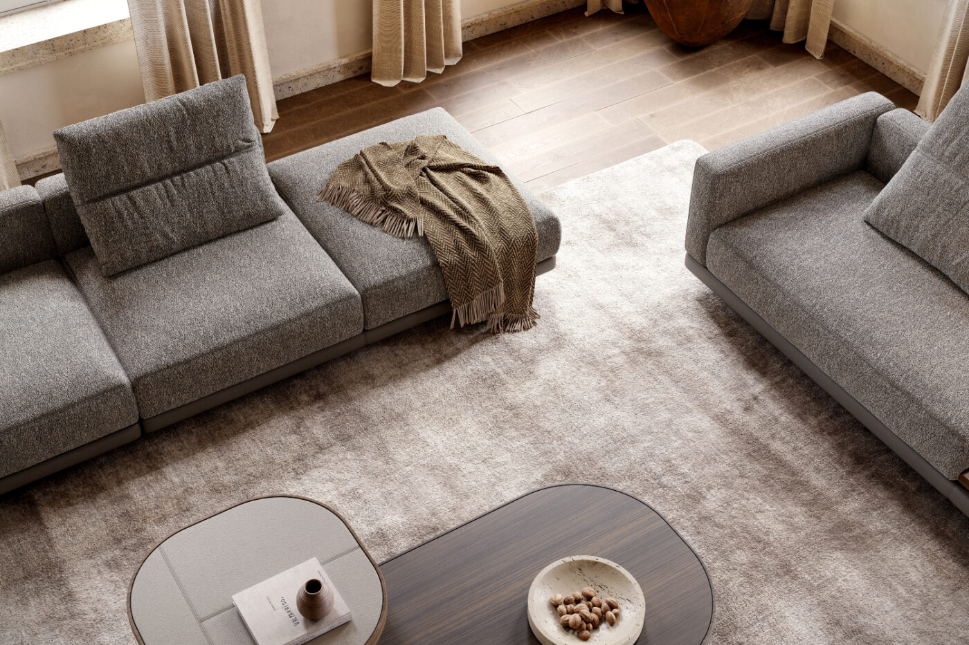 A bright living room with two comfortable modules of a modular sofa and a stylish coffee table at the centre. Custom-made furniture pieces.