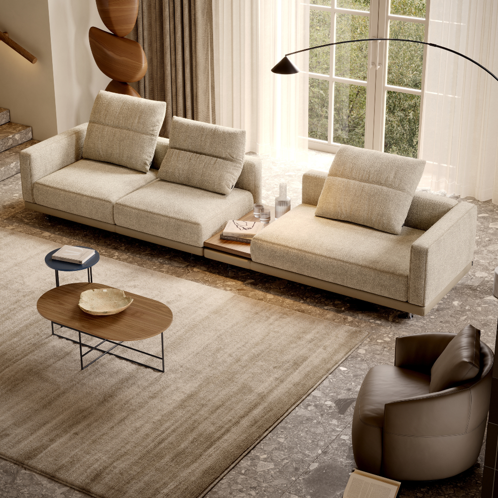 A stylish living room with a comfortable sofa, a coffee table, and a lamp, designed for relaxation and socialising.
