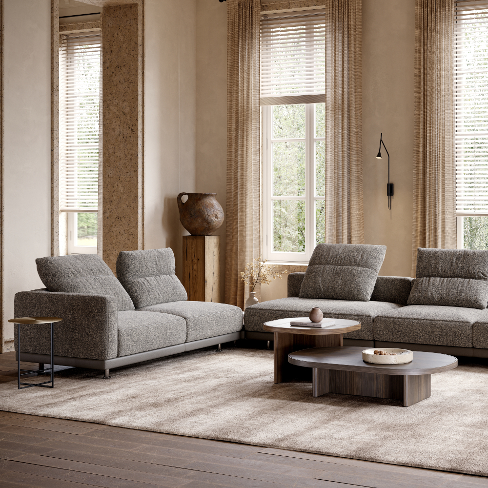 A modern living room showcasing a sofa, a coffee table, and a table, designed for comfort and socialising.