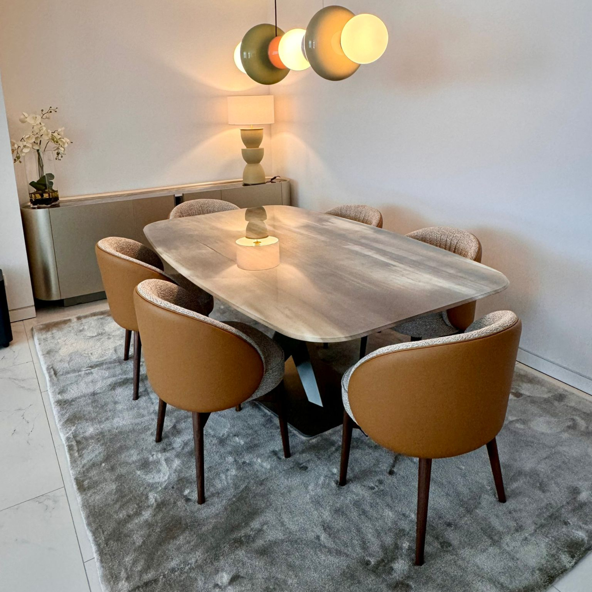 Design Stories: Modern dining area with a polished marble table and chic chairs, creating a sophisticated atmosphere.