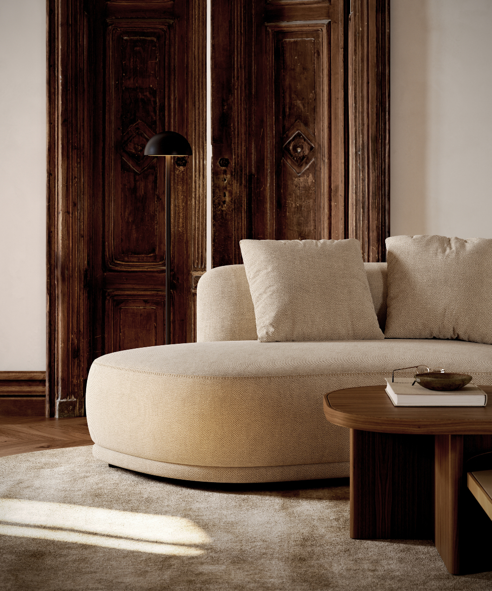 A brown living room with a modular sofa and a modern coffee table in the centre.