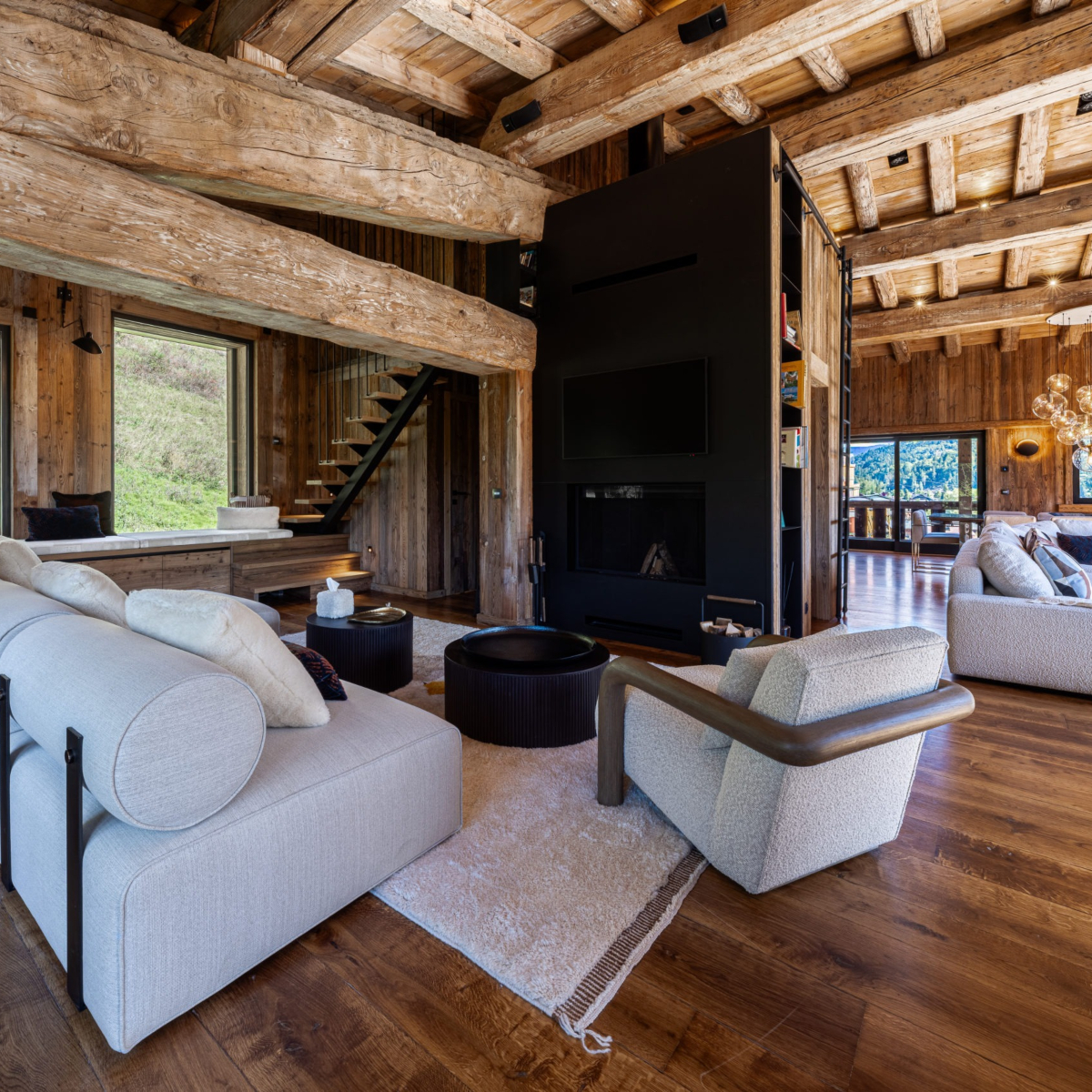A spacious living room showcasing a wooden ceiling and a comfortable white sofa, enhancing the room's elegance.
