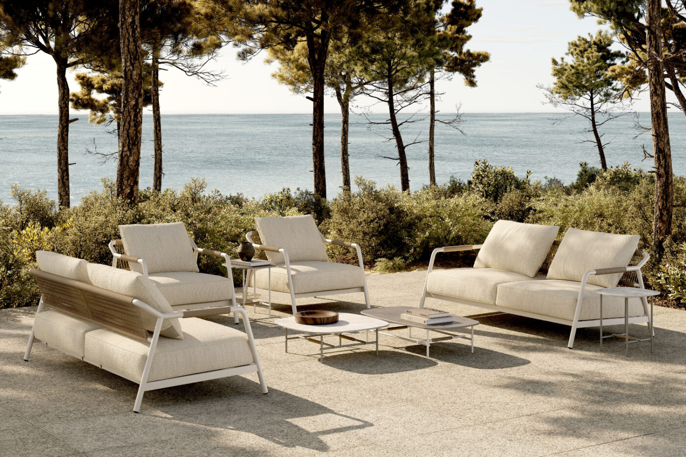 Outdoor patio furniture set with a table and white sofas, ideal for dining or lounging in a garden setting. Room by room design.