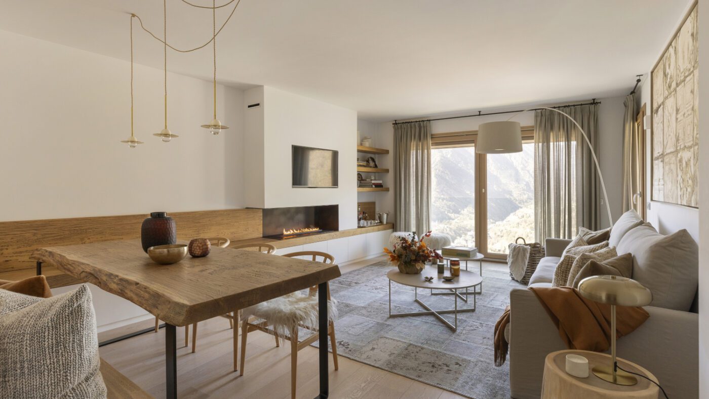 padresinteriors-piedaterre0 (1) Interior of a modern apartment with a wooden dining table and chairs, highlighting a sleek and inviting living space. By one of the best interior designers in Andorra.