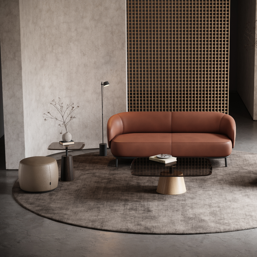 A contemporary living room with a red sofa and pouf, designed for comfort and elegance in a warm setting. Coffee table styling