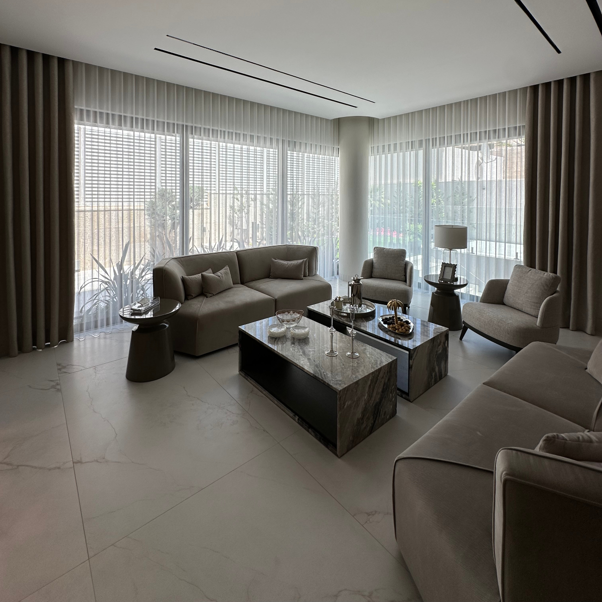 A bright living room by etch & notch designs with a spacious window and a plush modular sofa, creating a warm and inviting atmosphere.