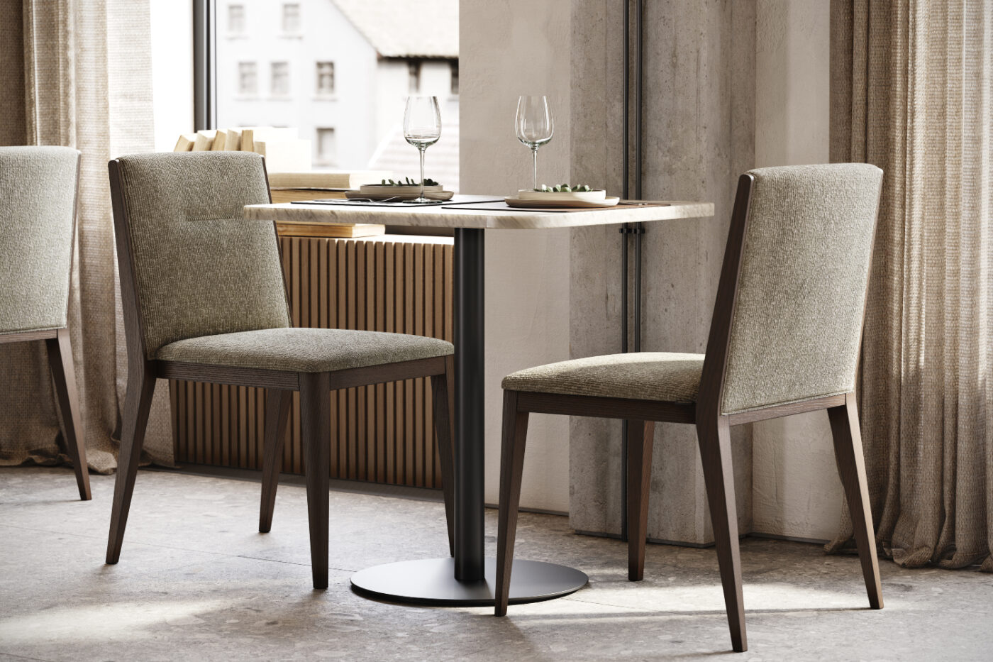 A table with two chairs positioned in front of a window, allowing natural light to illuminate the space. Restaurant interior design.