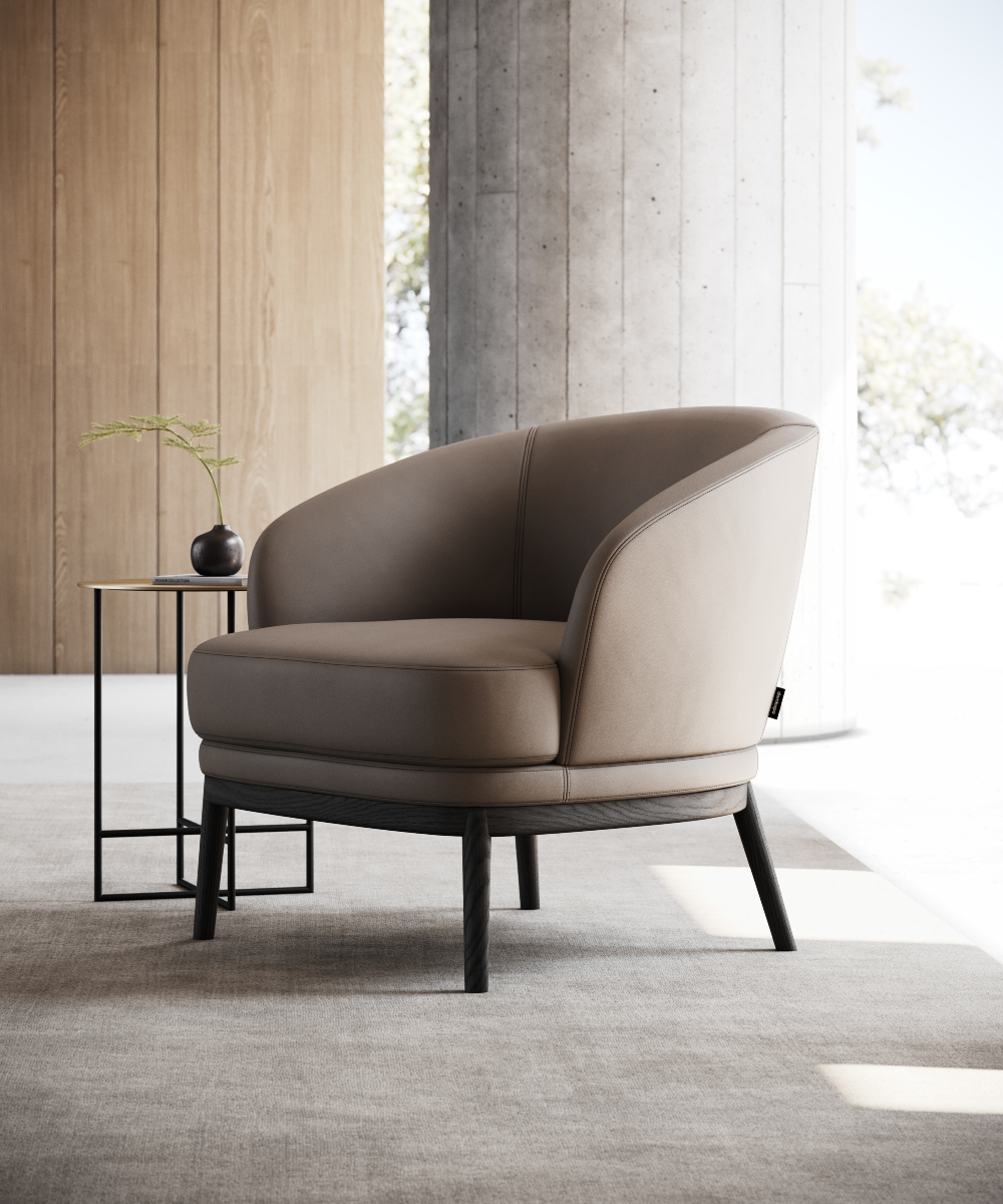 A contemporary brown armchair positioned beside a table in a well-lit room.