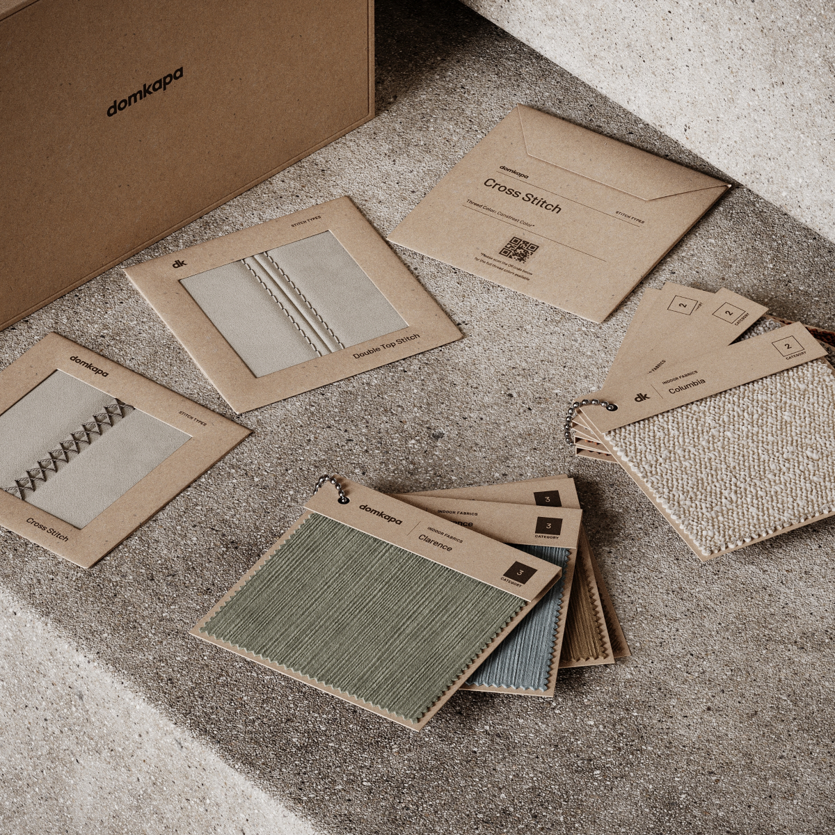 A box filled with various fabric and stitches samples, perfect for selecting custom-made furniture.