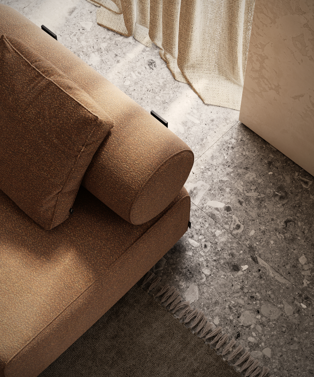 A comfortable modular sofa in cinnamon tones featuring a pillow, situated on an unadorned floor. Perfect for brown interiors.