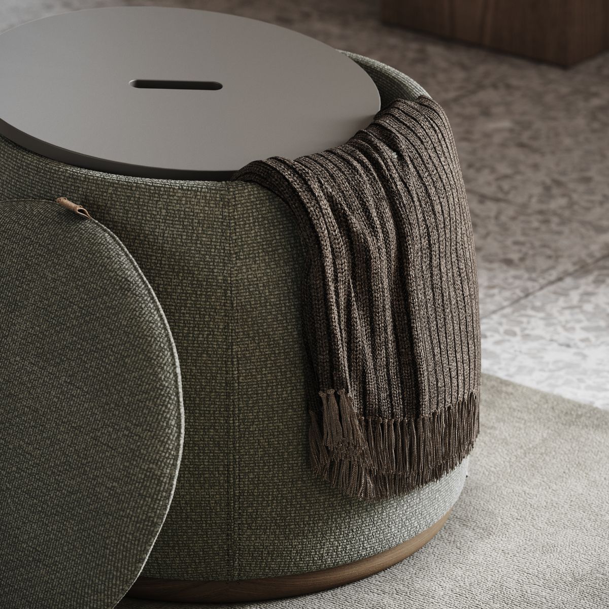 upholstered poufs selection (2) A green upholstered pouf with a brown knit throw draped over it, set on a patterned tile floor. The scene conveys a cosy, inviting atmosphere.