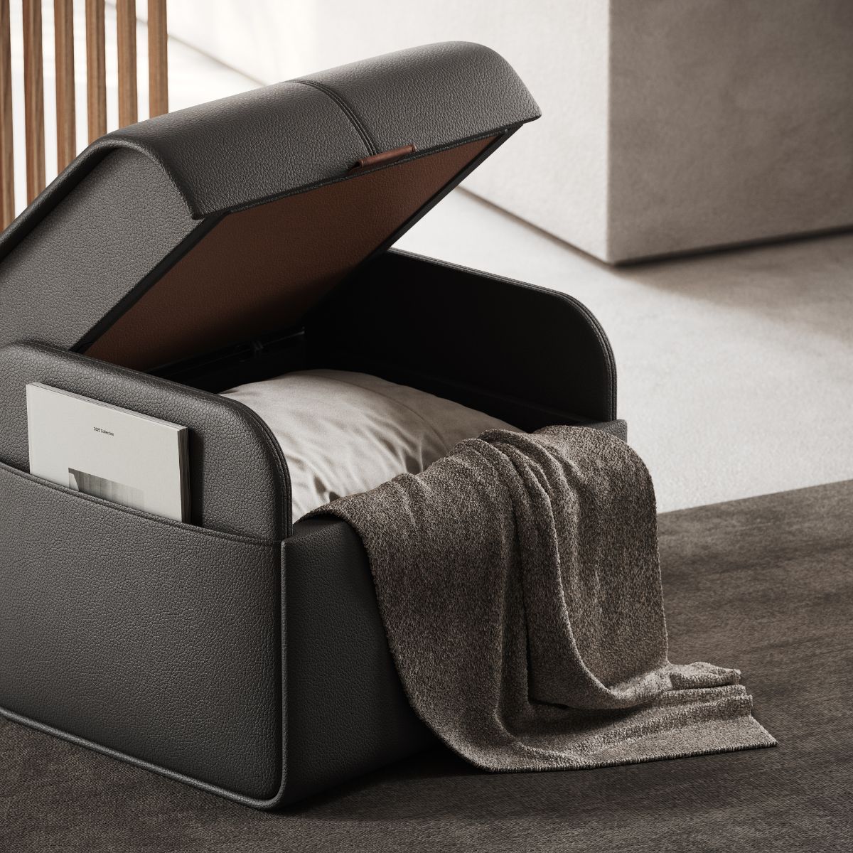 upholstered poufs selection A modern, open black storage upholstered pouf with a pillow inside, a soft gray blanket draped over, and a magazine in the side pocket. Minimalist and cosy.